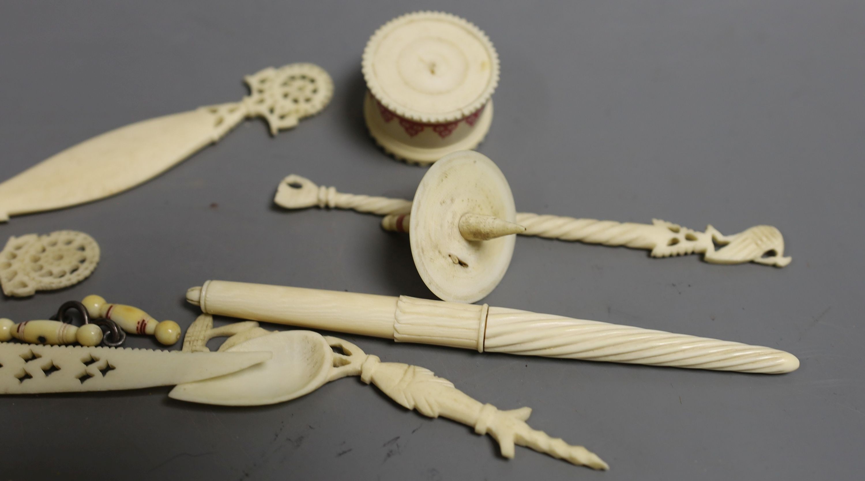 A group of 19th century/early 20th century carved ivory chains, sewing accessories, bracelets etc.
